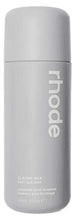Skincare milk bottle with RHODE branding and white cap