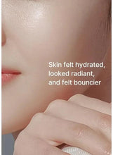 Skin with toner being spread by a hand for a hydrated look