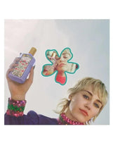 Gucci Flora Gorgeous Magnolia eau de parfum bottle held by hand, purple with gold cap.