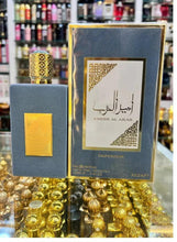 Blue perfume bottle with gold cap and gold-trimmed box