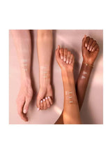 Foundation shade swatches on forearms, varying beige tones