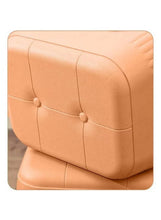 Orange plastic stool seat with stitched panel lines and button details