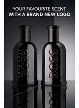Black eau de parfum bottles with cylindrical caps and embossed logo
