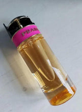 Eau de parfum bottle with black cap, pink band label, amber liquid in glass