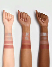 Hand swatches of rose-gold shimmer and mauve-to-brown eyeshadow on skin