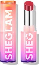 Red high-shine lipstick in clear tube with silver cap; glossy tip visible