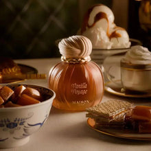 Eau de parfum bottle, rounded amber glass with cream ribbed cap and gold emblem