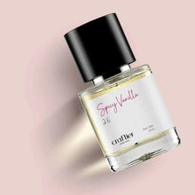 Spray perfume bottle at angle with black cap and clear golden Spray Vanilla label