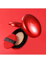 BB cream compact with red metallic lid open, showing beige cushion refill