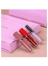 Lip gloss and lip oil bottles in clear tubes with red and nude shades, in box