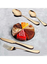 Rose gold stainless steel fork and spoon near dessert slices