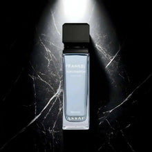 Perfume bottle with black cap and clear glass, ASSAF logo on front.