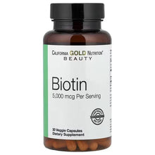 Biotin supplement bottle with black cap, brown capsules, front label view