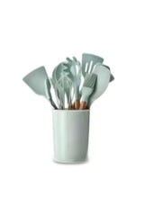 Light gray silicone cooking utensil set with wooden handles in a matching holder
