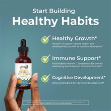 Hand holding MaryRuth's toddler multivitamin liquid drops bottle, orange vanilla