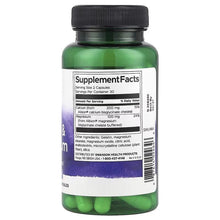 Calcium & magnesium supplement bottle with Supplement Facts panel and green capsules visible