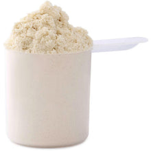 Vanilla whey protein powder scoop with fine powder in white container
