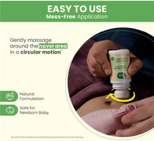 Baby tummy roll-on in hand, white bottle with green label applying near naval area