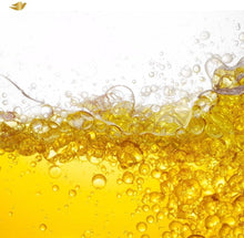 Golden bi-phasic oil-serum liquid with bubbles, shown in a splash