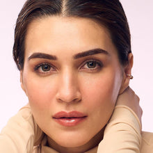 Model with peach-nude tinted, glossy lips wearing hazel lip balm.