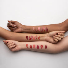 Arms showing liquid blush swatches in multiple red tones