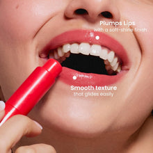 Red tinted lip balm applied to lips with glossy finish