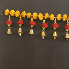 Pom-pom door hanging with yellow beads, red tassels, and gold bells