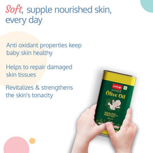 Hands holding LuvLap Naturals Olive Oil baby massage can with green label
