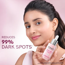 Brightening serum bottle held near face for application