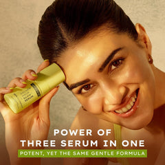 Hyphen Golden Hour Glow face serum bottle held near cheek, lime green cap