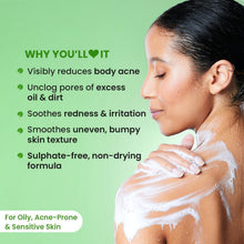 Woman in the shower with white lather on her shoulder, using exfoliating shower gel