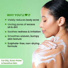 Woman in the shower with white lather on her shoulder, using exfoliating shower gel