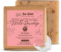 Two handmade cold-processed soap bars, tan and brown, with pink front label