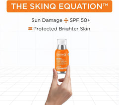 SkinQ sunscreen SPF 40 PA++++ bottle in orange label and clear cap, held in a hand