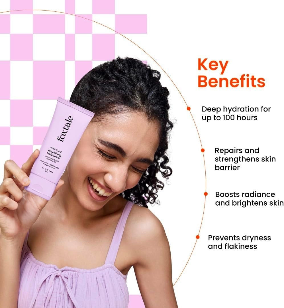 Foxtale nourishing face moisturizer tube held beside smiling woman’s cheek