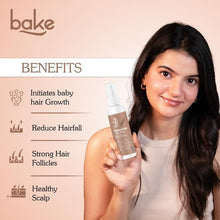BAKE rosemary oil + rice water serum spray bottle with pump, shown in hand