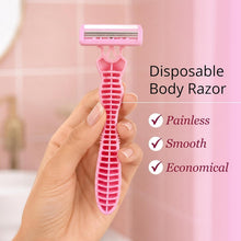 Hand holding a pink disposable body razor with multi-blade shaving head