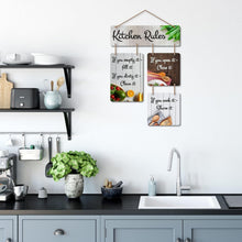 Kitchen rules wall hanging mounted on a white kitchen wall with four quote panels