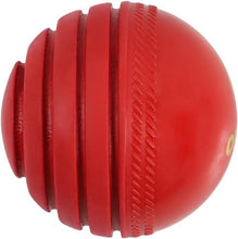 Red cricket wobble practice ball with ridged grip segments and side seam