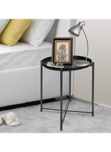 Round black side table with tray top and three legs