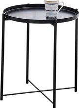 Round black side table with tray top and a mug on top