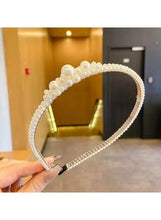 Girls' white pearl headband with beaded edge and central pearl detail, held up