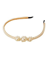 White pearl beaded headband with central large pearl and smooth curved band