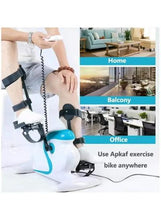White mini pedal exerciser with teal pedal arms, black padded straps, and power cord