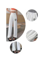 White wide-leg pants: gathered elastic waistband and pleated drape with logo