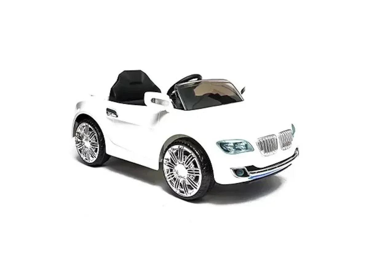 White kids electric ride-on car with black seats, angled side view, chrome wheels.