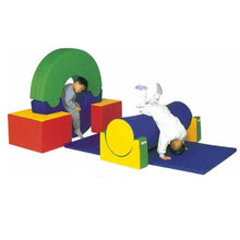 Soft play zone with foam climbing blocks, green tunnel, blue mat, and yellow arch