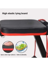 Padded bench seat with black upholstery and red trim, lying board close-up