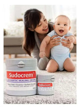 Sudocrem antiseptic healing cream jars on fabric surface