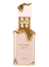 Lattafa Eclaire eau de parfum spray bottle, pink glass with gold cap and trim